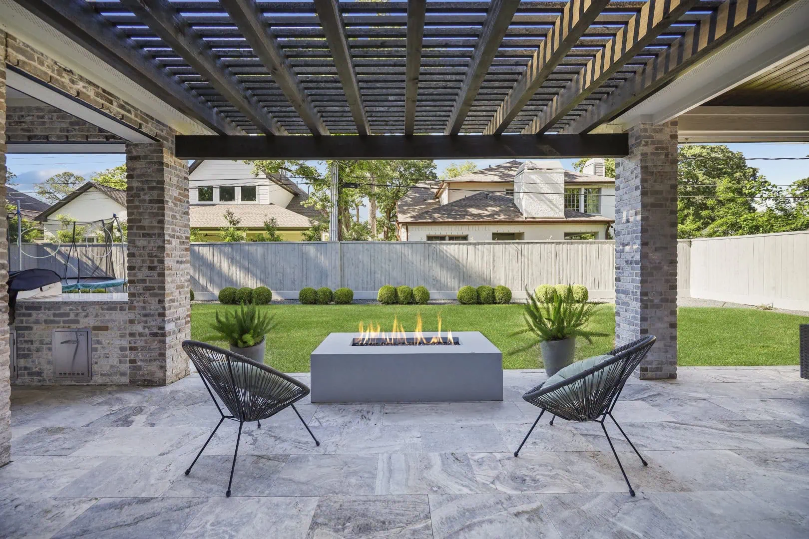 custom-patio-with-travertine-flooring-and-pergola